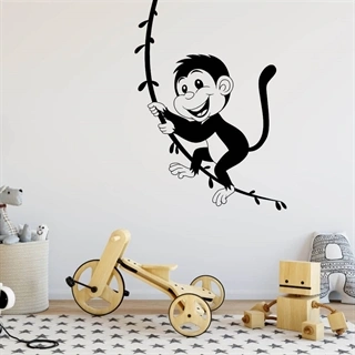 wallstickers med abe der svinger i en lian