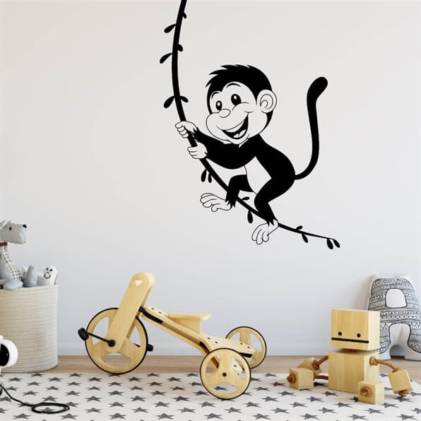 wallstickers med abe der svinger i en lian
